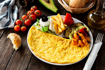 Tasty breakfast with omelette, grilled vegetables and other side dishes