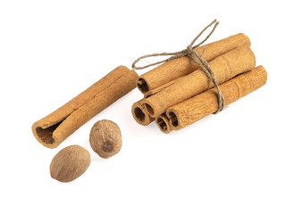 Cinnamon sticks with nutmeg on a white background