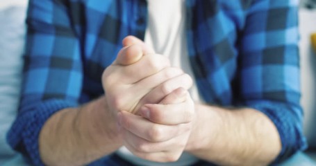 Close-up of wringing nervous man hands in blue shirts. The guy is very worried. Expectation. Waiting for an interview or hospital. - Powered by Adobe