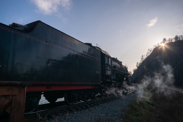 Angasolka, Russia - october 17, 2019 - Steam engine smokes while standing at the station