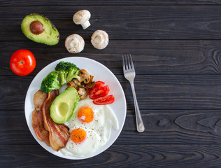 Ketogenic diet breakfast from above on brown table.