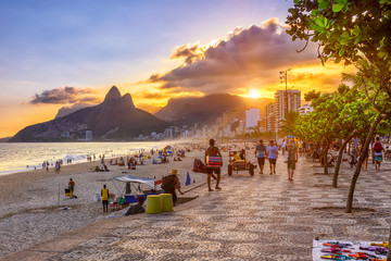 Sunset view of Ipanema beach with mosaic of sidewalk, Leblon beach and the Mountain Dois Irmao in Rio de Janeiro. Brazil - obrazy, fototapety, plakaty