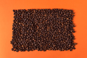 coffee beans on an orange trendy background with space for text
