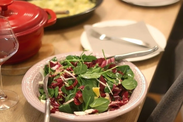 Spinach, chicory, fennel and orange salad served on the festive table setting. Selective focus. 