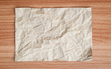 Brown creased paper texture background, Brown wrinkle recycle paper background on table wooden