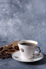 coffee cup and coffee beans on a gray background with space for your text