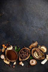 Fototapeta na wymiar Mushroom Chaga Coffee Superfood Trend-dry and fresh mushrooms and coffee beans on dark background