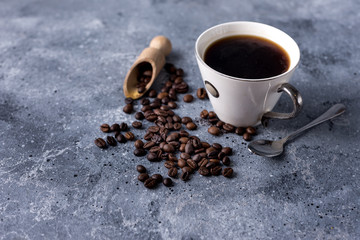 coffee cup and coffee beans on a gray background with space for your text