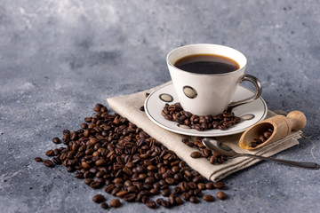 coffee cup and coffee beans on a gray background with space for your text