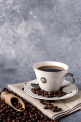 coffee cup and coffee beans on a gray background with space for your text