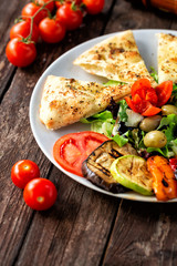 Tasty vegan dish with grilled and fresh vegetables