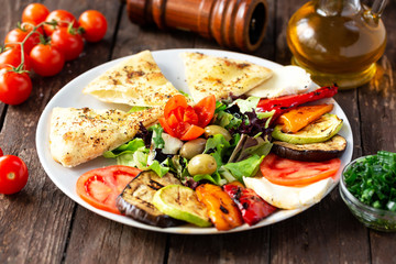 Grilled and fresh vegetables together on one plate