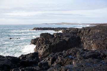 Fototapeta na wymiar Big waves crashing in rocks on the south west coast on Iceland
