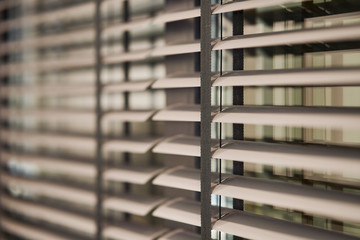 Gray plastic window blinds, close-up. 
