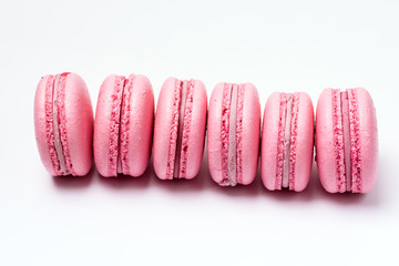 Obraz premium French Strawberry Macarons Six Pastel Macarons on White Background Pink Macarons Horizontal