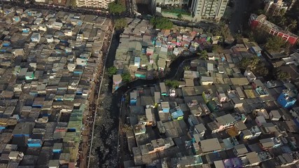 Two Different Mumbai Neighborhoods Tilt Up Aerial. Poor Dharavi Slum and Modern Buildings in Downtown.