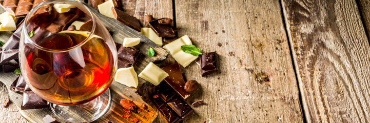 Strong alcohol drink. Glass of brandy, whiskey or cognac on the wooden table