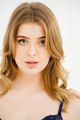 Fototapeta premium Gentle portrait of young healthy blond woman underwear near light window