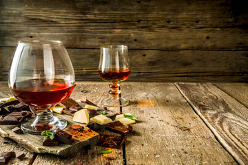 Strong alcohol drink. Glass of brandy, whiskey or cognac on the wooden table