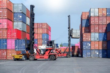 Container handlers are loading containers into trucks.