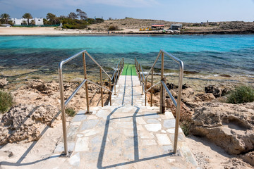 Stair descent to the beach. Azzure water and Nissi beach in Aiya Napa, Cyprus