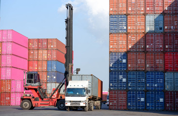 Container handlers are loading containers into trucks.
