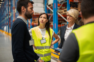 Warehouse staff meeting, workers with mnagers