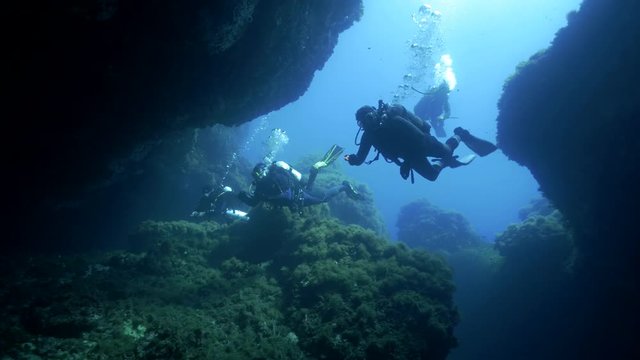 Scubadivers in water cave
