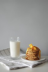 Stack of handmade oatmeal cookies with glass of milk