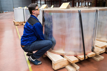 Worker at plant shows how to properly lift a load. Safety at work. Insurance