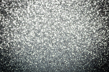Metallic foil background. Shiny metal silver foil texture abstract defocused background. Sparkle glitter texture with bokeh lights