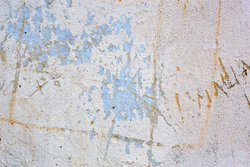 Old colorful grungy cracked concrete wall paint peeling off background