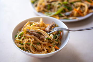 Stir fried Korean glass noodle with soy sauce called Japchae