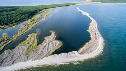 Aerial view over complex coastal development - the gravel spits created by storms forming new...