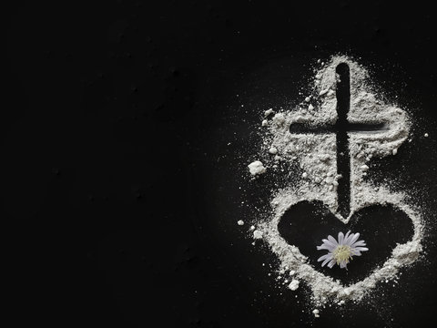 Lent Season,Holy Week and Good Friday concepts - Image of ash in shape of heart and cross with purple flower on dark background