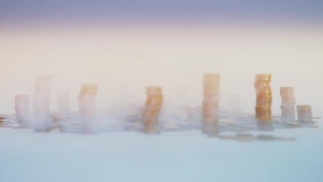 The concept of money. Columns of gold coins in the form of skyscrapers or Stonehenge. Close-up hands make up stacks of coins. Smoke. Garland.