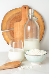 Fototapeta na wymiar milk in a bottle and in a glass and cottage cheese on a white background
