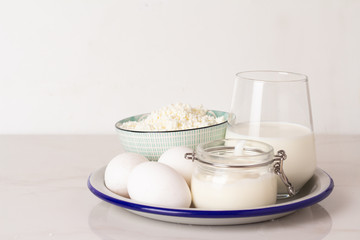 eggs, cottage cheese and milk on a plate and place for text