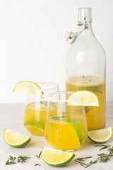lime drink in a glass with salt and citruses and a bottle with a drink