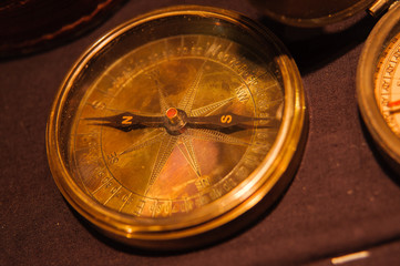  Many vintage compasses in showcase of the shop