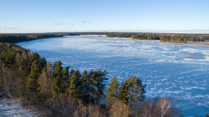 Obraz premium Aerial view over frozen lake with ice and snow wall formations, Southern Estonia, Võru county, Lake Hino