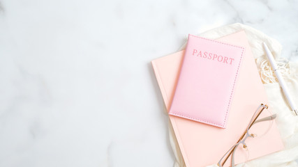 Travel and summer vacations concept.Stylish feminine accessories, passport, pink paper notebook,...
