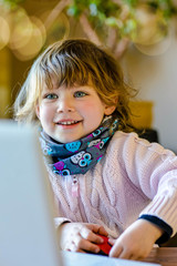 cute little girl using a computer