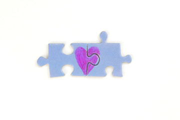 Blue puzzle with a red heart on the white isolation background. Valentine's day stock photo with empty space for your text. For web, print, postcard, background and wallpaper 