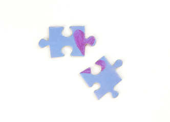 Blue puzzle with a red heart on the white isolation background. Two disconnected puzzle halves. Valentine's day stock photo with empty space for text.For web, print, postcard, background and wallpaper