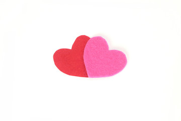 Two felt heart red and pink color on a white isolated background. Stock photo for the day of St. Valentine with empty space for your text. For web, print, postcards and wallpaper.