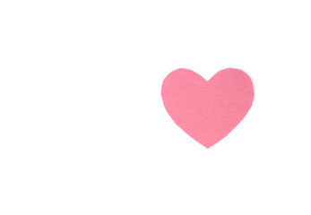 Оne pink felt heart on a white isolated background. Stock photo for the day of St. Valentine with empty space for your text. For web, print, postcards and wallpaper.