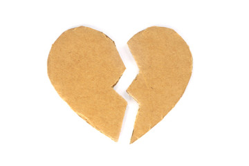 Broken cardboard heart on an isolated white background. Two halves of the heart. The concept of a broken heart, unrequited love. Valentine's Day stock photo with empty space for your space
