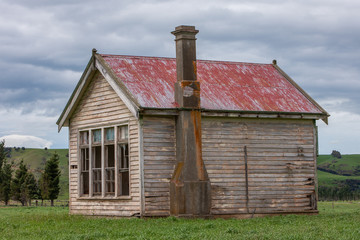 Fototapeta na wymiar Abandoned wooden schoolbuilding. Blackmount Road. Invercargill. New Zealand. South Island. Coast