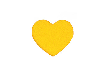 Оne felt yellow heart on a white isolated background. Stock photo for the day of St. Valentine with empty space for your text. For web, print, postcards and wallpaper.